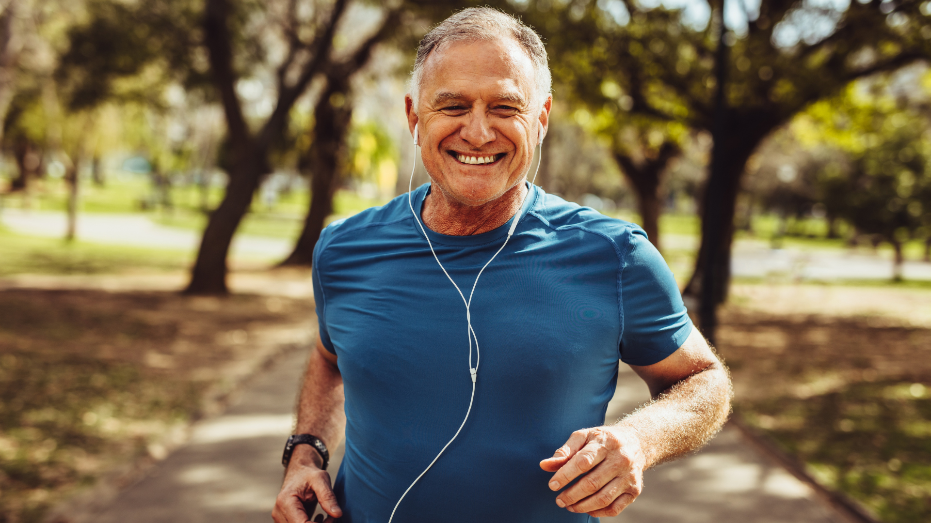An image of a happy elderly man going for a jog